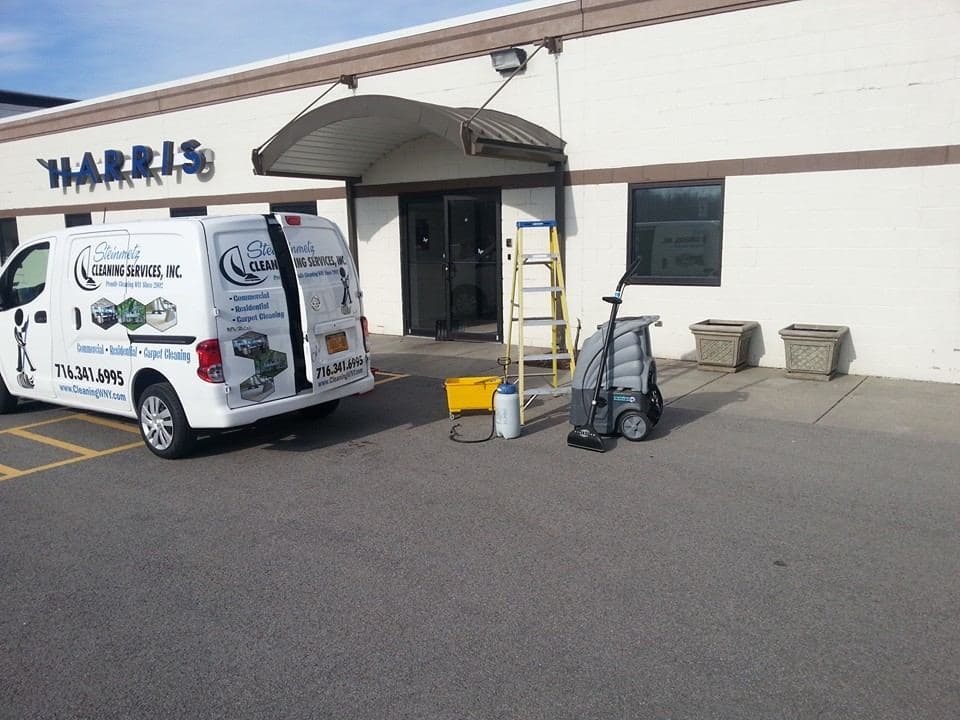 A Steinmetz Cleaning Services van and floor equipment outside a Western New York commercial building