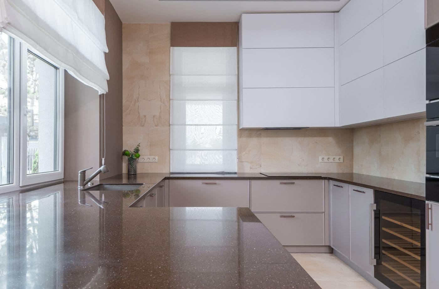 A kitchen with clear counter tops and a freshly mopped floor catching the light