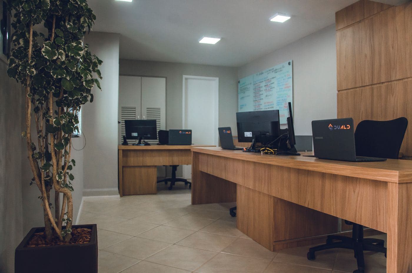 A clean reception and workstation area with clear desks ready for the working day